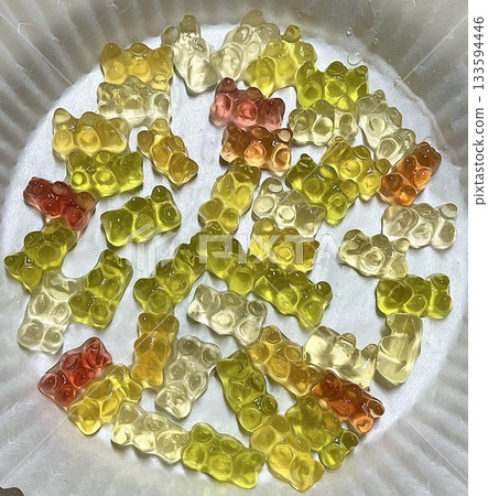 Bright and colorful gummy bears with a chewy texture and fruity flavors. These fun and playful treats are perfect for snacking, sharing, or adding a splash of sweetness to any occasion. 133594446