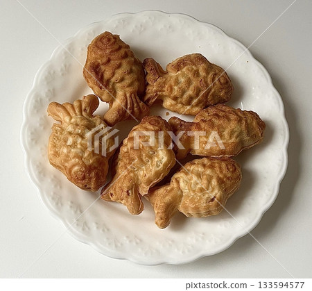 Crispy and golden mini bungeoppang with a soft, fluffy filling of sweet red bean or custard. A delightful bite-sized Korean fish-shaped pastry, perfect for a warm and nostalgic treat! Crispy and golden mini bungeoppang with a soft, fluffy filling of sweet red bean or custard. A delightful bite-sized Korean fish-shaped pastry, perfect for a warm and nostalgic treat! 133594577