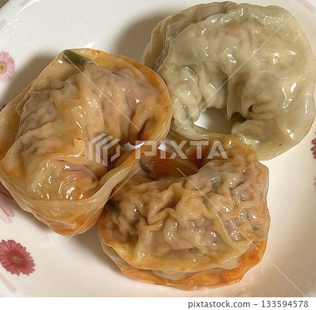Korean dumplings filled with a mix of savory ingredients like ground meat, tofu, and vegetables. Mandu can be steamed, boiled, or pan-fried, making it a versatile and delicious snack or meal. Korean dumplings filled with a mix of savory ingredients like ground meat, tofu, and vegetables. Mandu can be steamed, boiled, or pan-fried, making it a versatile and delicious snack or meal. 133594578