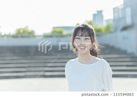 Woman running around an outdoor stadium Woman running around an outdoor stadium 133594863