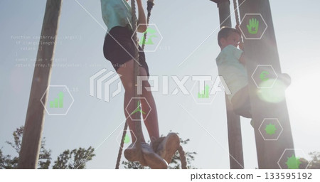 Climbing school-aged boys ascending wooden poles using thick ropes at park, with green data icons Climbing school-aged boys ascending wooden poles using thick ropes at park, with green data icons 133595192