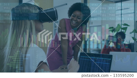 Woman using VR headset and visualizing data in office space, with laptops and plants, copy space 133595200