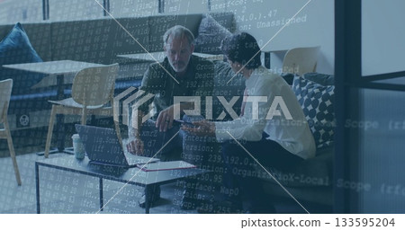 Two men in shirt and tie, green jacket coding on laptop in office lounge, with notebook Two men in shirt and tie, green jacket coding on laptop in office lounge, with notebook 133595204