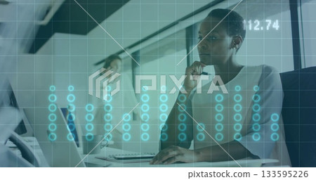 African American woman holding pen and gazing at laptop in office, with notebook, mug, copy space African American woman holding pen and gazing at laptop in office, with notebook, mug, copy space 133595226