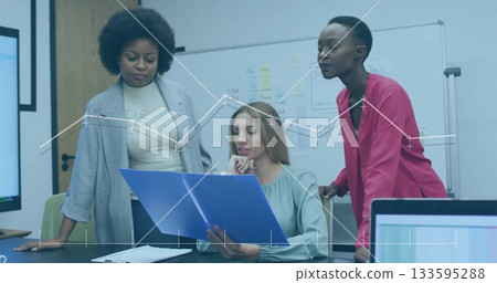 Leaning three colleagues wearing blazers reviewing report in conference room, with blue folder Leaning three colleagues wearing blazers reviewing report in conference room, with blue folder 133595288