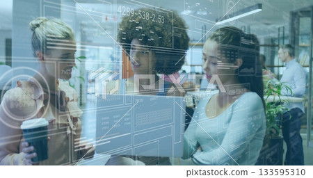 Collaborating professionals reviewing laptop data in office with coffee cup and analytics overlay Collaborating professionals reviewing laptop data in office with coffee cup and analytics overlay 133595310