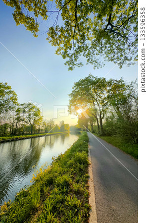 Experience a Serene Landscape Featuring a River and Pathway at the Beautiful Sunset Time 133596358