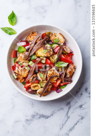 Italian panzanella with anchovies, olives and tomatoes. 133596685