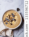 Chocolate smoothie bowl with banana, blueberries and nuts. 133596712