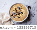 Chocolate smoothie bowl with banana, blueberries and nuts. 133596713