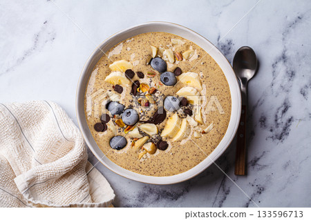 Chocolate smoothie bowl with banana, blueberries and nuts. Chocolate smoothie bowl with banana, blueberries and nuts. 133596713