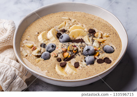 Chocolate smoothie bowl with banana, blueberries and nuts. Chocolate smoothie bowl with banana, blueberries and nuts. 133596715