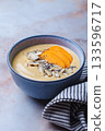 Persimmon smoothie bowl with chia seeds and nuts. 133596717