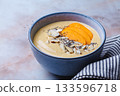 Persimmon smoothie bowl with chia seeds and nuts. 133596718