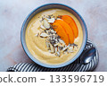 Persimmon smoothie bowl with chia seeds and nuts. 133596719