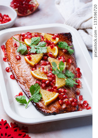 Christmas salmon in pomegranate juice with orange and pomegranate seeds. Christmas salmon in pomegranate juice with orange and pomegranate seeds. 133596720