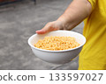 Spicy instant noodles bowl and hand 133597027