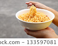 Spicy instant noodles bowl eating and hand 133597081