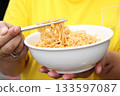 Spicy instant noodles bowl eating and hand 133597087