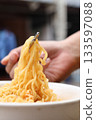 Spicy instant noodles bowl eating and hand 133597088