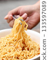 Spicy instant noodles bowl eating and hand 133597089