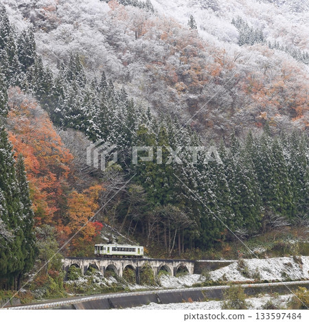 Tadami Line of autumn leaves and snow scene 133597484