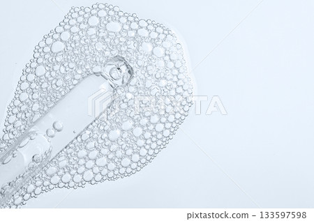 The texture of the foam of shower gel or soap suds or shaving foam. Macrophotography. Copy space 133597598