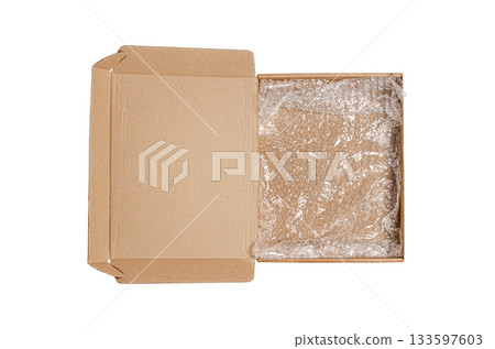 An open cardboard box with bubble wrap. The concept of packaging parcels with fragile cargo. Isolated on white. 133597603