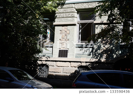 Photovoltaic solar panel in front of historical building. Concept of integration of sustainable renewable energy sources into old architecture. Photovoltaic solar panel in front of historical building. Concept of integration of sustainable renewable energy sources into old architecture. 133598436