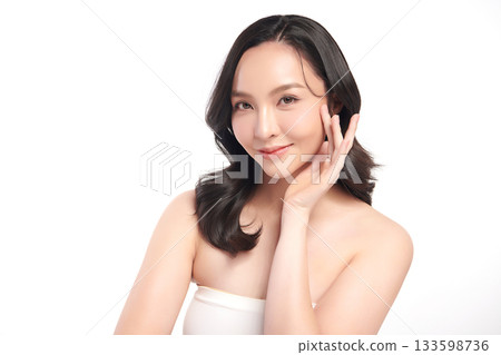 A beautiful young Asian woman with clean, fresh skin against a white background. Skincare, facial treatment, cosmetology, beauty, and spa. An elegant portrait of an Asian woman. A beautiful young Asian woman with clean, fresh skin against a white background. Skincare, facial treatment, cosmetology, beauty, and spa. An elegant portrait of an Asian woman. 133598736