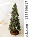 White room with stairs and a stylish Christmas tree decorated with black and white ornaments 133599017