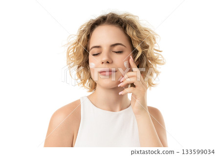 Woman applies moisturizer while relaxing, isolated on white, PNG 133599034