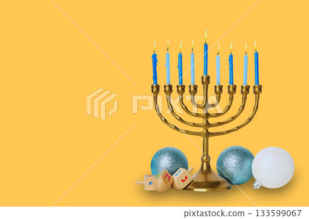 Blue candle menorah next to festive decor 133599067