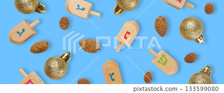 A vibrant arrangement of dreidels and ornaments with pine cones 133599080
