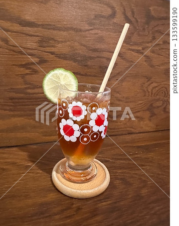 Lime Iced Tea in a Flower-Shaped Glass 133599190