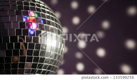 Shiny party ball reflects colors, party mood grows, party night begins 133599258