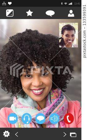 Flat phone interface showing smiling woman in pink coat and scarf with inset friend, control icons Flat phone interface showing smiling woman in pink coat and scarf with inset friend, control icons 133599391
