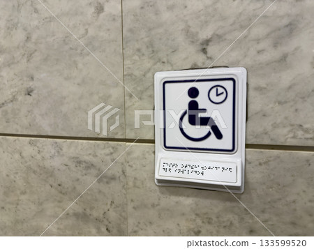 The best accessible sign with Braille text for reading using tactile dots. The concept of finger reading by tracing raised dots on text for people with disabilities 133599520