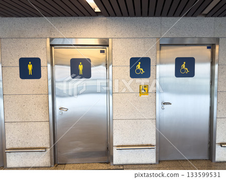 Wall with entrance doors to disabled and men restroom. Two different doors demonstrate care provided to people with disabilities. Separate, specialized restroom for wheelchair user Wall with entrance doors to disabled and men restroom. Two different doors demonstrate care provided to people with disabilities. Separate, specialized restroom for wheelchair user 133599531