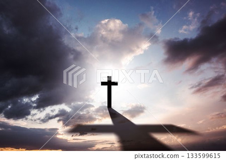 Flat design featuring cross silhouette casting long shadow over platform under cloudy gradient sky 133599615