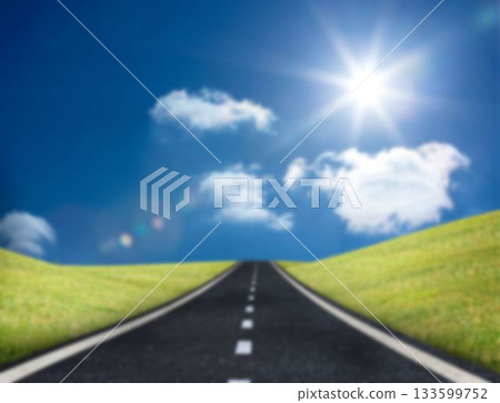Road leading to horizon against blue sky 133599752