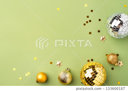 Christmas gold ornaments on a green background. 133600187