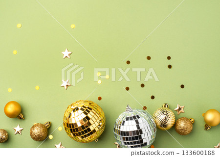 Christmas gold ornaments on a green background. 133600188