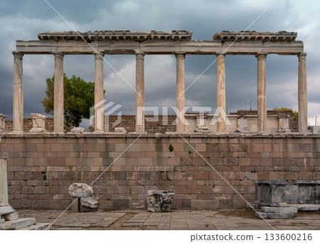 Majestic ancient colonnade at Pergamon Acropolis, Bergama, Turkey, under a dramatic cloudy sky. Majestic ancient colonnade at Pergamon Acropolis, Bergama, Turkey, under a dramatic cloudy sky. 133600216