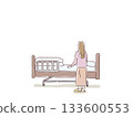 Back view of a woman looking at a nursing bed Back view of a woman looking at a nursing bed 133600553