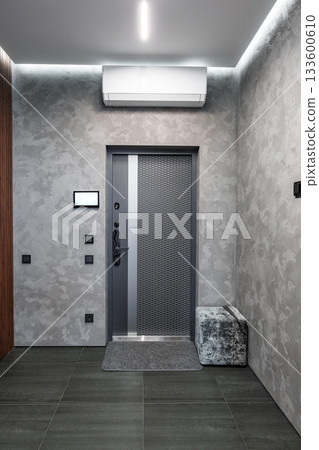 Modern entrance featuring sleek design and a neutral color palette in a contemporary setting 133600610