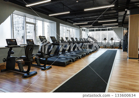 Modern gym interior with exercise equipment in a spacious fitness center 133600634