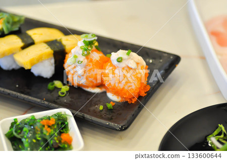 shrimp egg rolls or rice topped with fish or Japanese rolls 133600644
