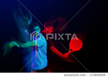 Dynamic action in sports with colorful lighting showcasing racket techniques Dynamic action in sports with colorful lighting showcasing racket techniques 133600689
