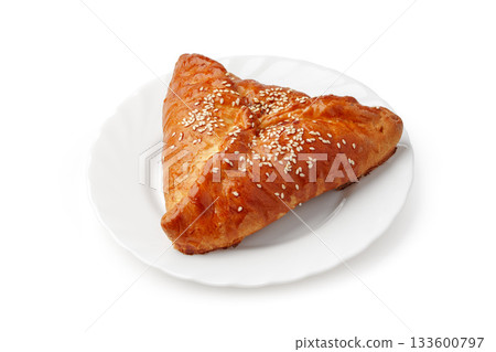 Delicious pastry on a white plate with sesame seeds ready to be enjoyed Delicious pastry on a white plate with sesame seeds ready to be enjoyed 133600797